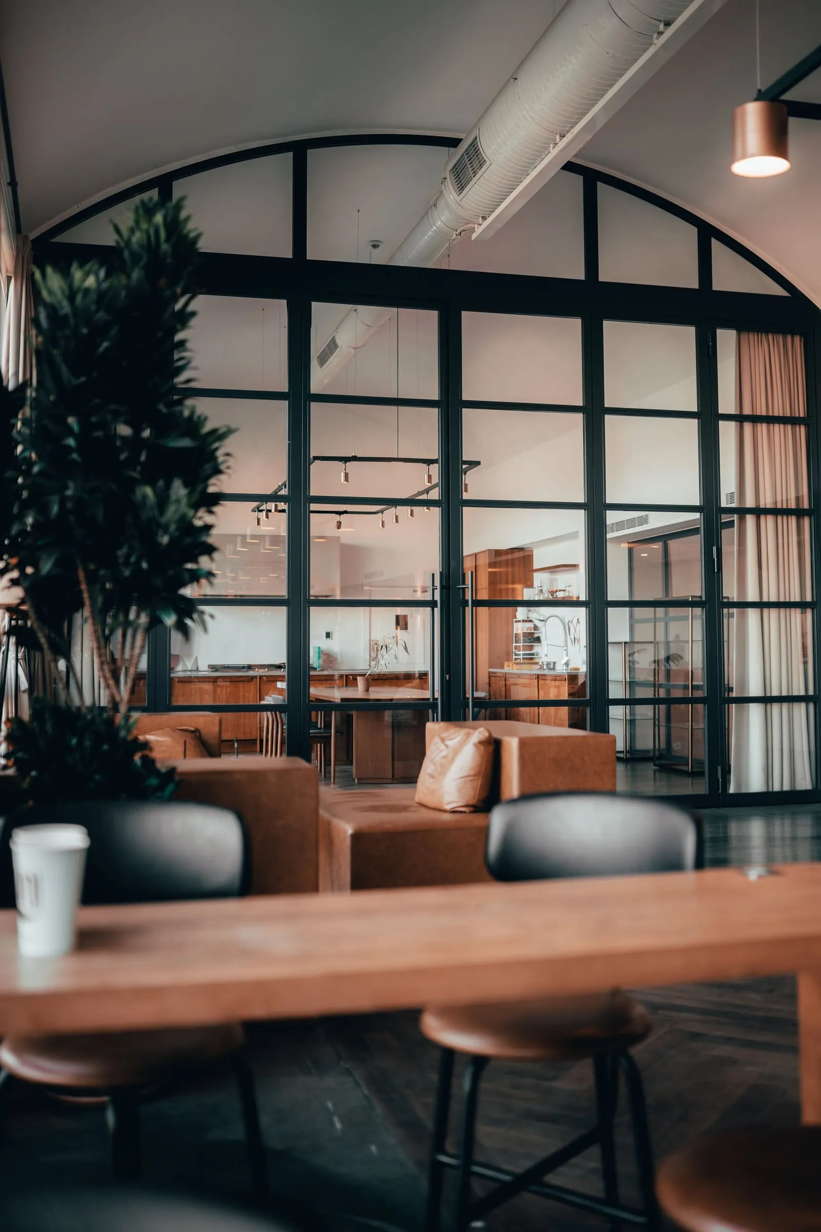 Floor-to-ceiling black-framed glass partitions